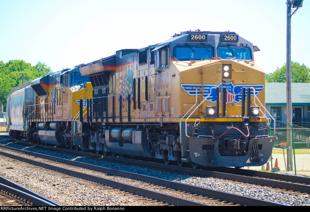 Westbouns NS manifest with UP power passing the Amtrak station approaching the yard 